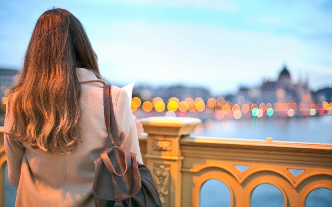 woman wearing trench coat and black leather backpack